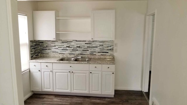 kitchen featuring white cabinets, backsplash, dark hardwood / wood-style flooring, and sink