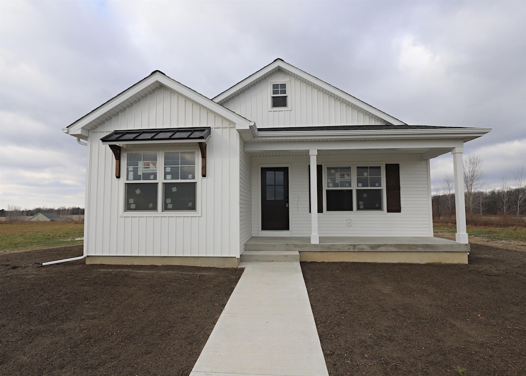 3304 Heritage Blvd, Swartz Creek, MI 48473 - view of front of home with a porch and board and batten siding