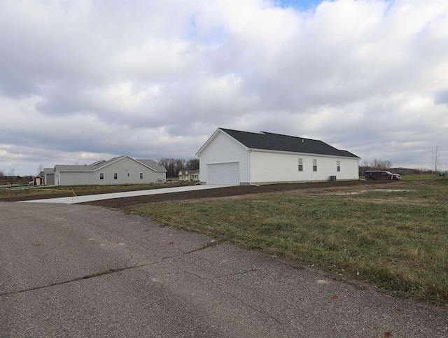 view of home's exterior featuring a lawn and a garage