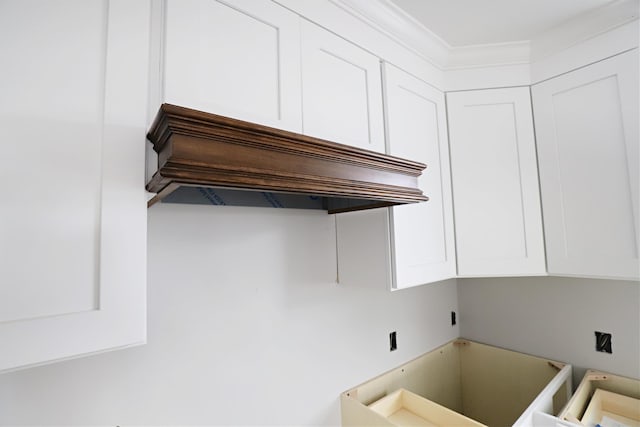 kitchen with white cabinets and premium range hood