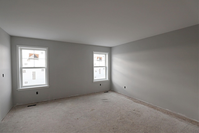 carpeted empty room featuring a healthy amount of sunlight