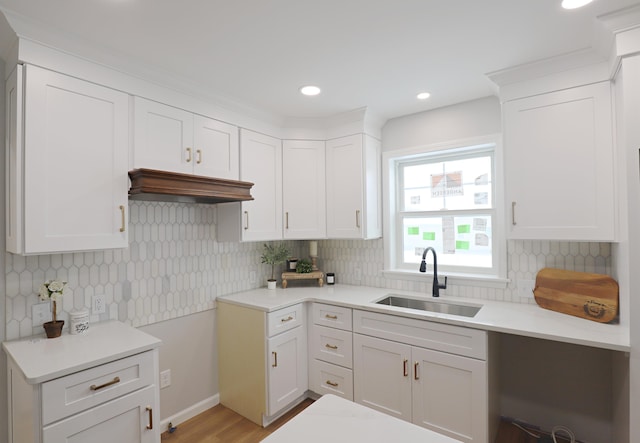 kitchen with white cabinetry, sink, and decorative backsplash