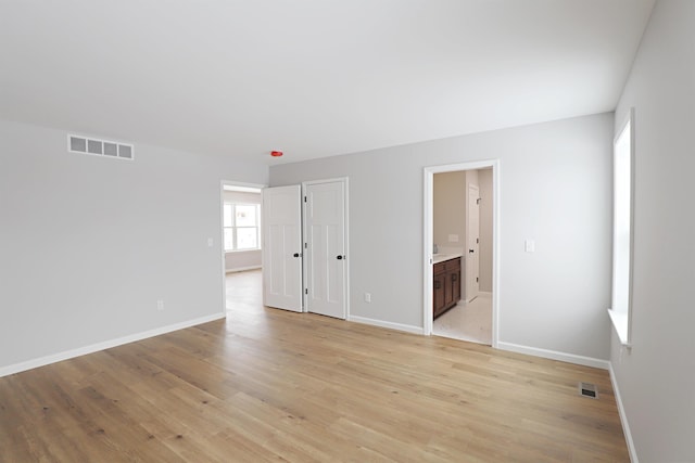 spare room featuring light hardwood / wood-style floors