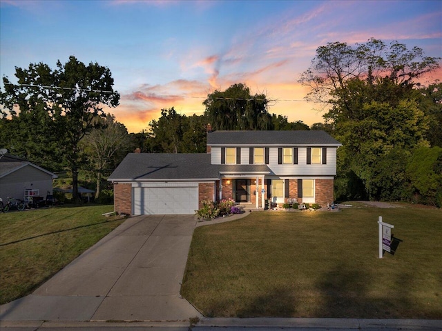 view of front facade featuring a garage and a yard