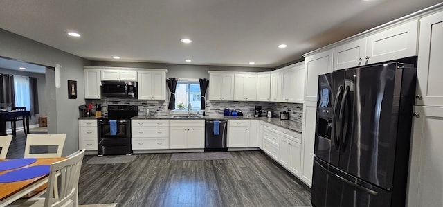 kitchen featuring decorative backsplash, dark wood-type flooring, sink, black appliances, and white cabinets