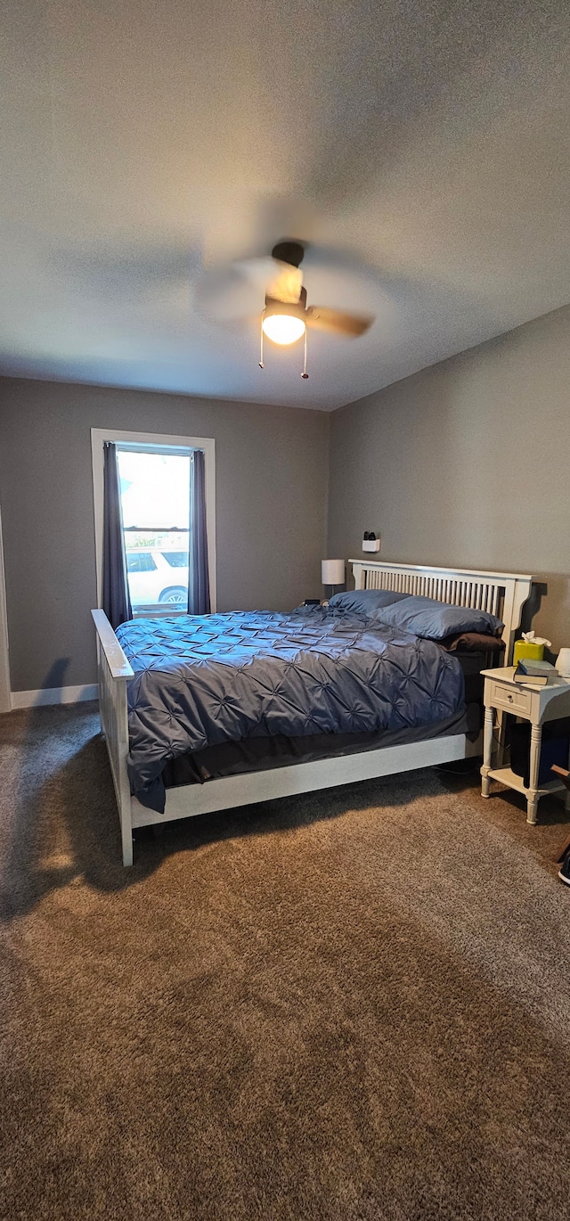 bedroom featuring carpet, ceiling fan, and a textured ceiling