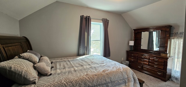 carpeted bedroom with vaulted ceiling