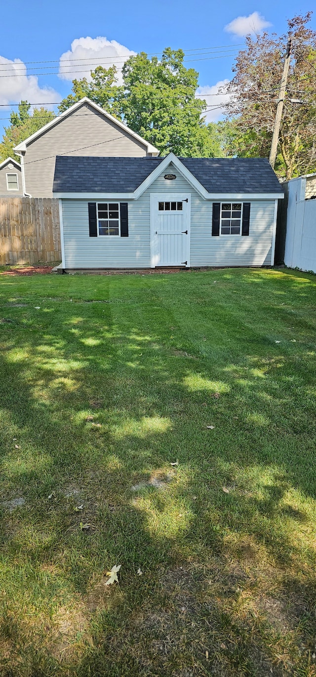 view of outbuilding with a yard