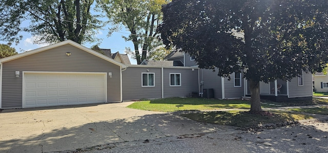 view of front facade with a garage and a front lawn