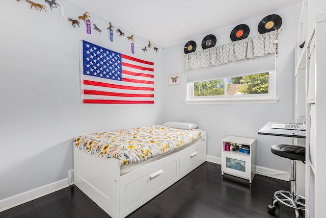 bedroom with dark wood-type flooring