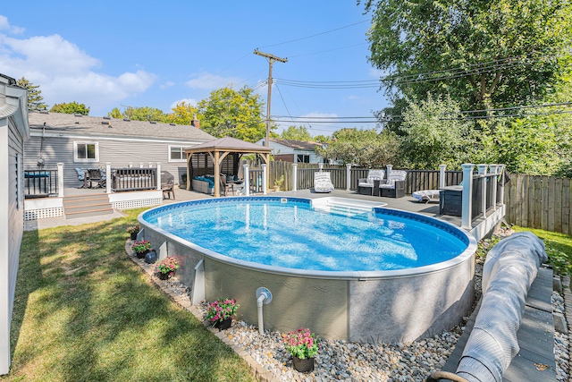 view of swimming pool with a gazebo, an outdoor living space, a yard, and a wooden deck