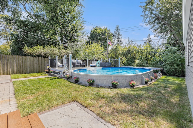 view of swimming pool featuring a yard and a deck