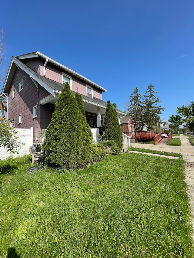 view of side of property with a yard