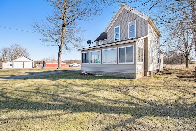 view of side of property featuring a sunroom and a yard