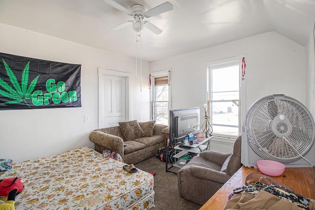 carpeted living room with ceiling fan and lofted ceiling