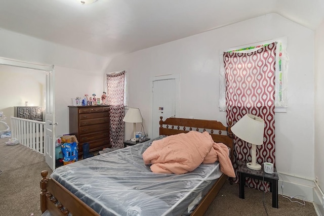 bedroom featuring carpet floors and vaulted ceiling