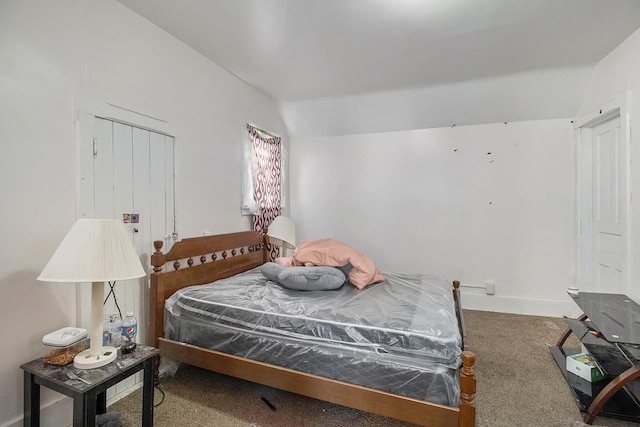 bedroom featuring carpet and vaulted ceiling