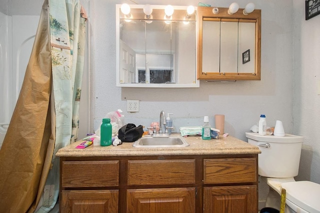 bathroom featuring vanity, toilet, and curtained shower