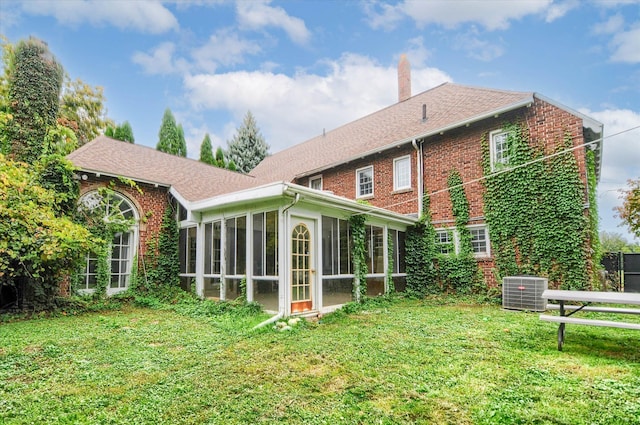 back of property featuring central AC and a sunroom