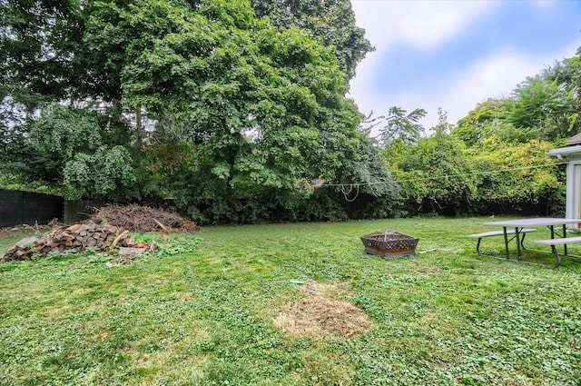 view of yard with an outdoor fire pit