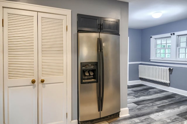 kitchen with stainless steel refrigerator with ice dispenser, radiator, and dark wood-type flooring