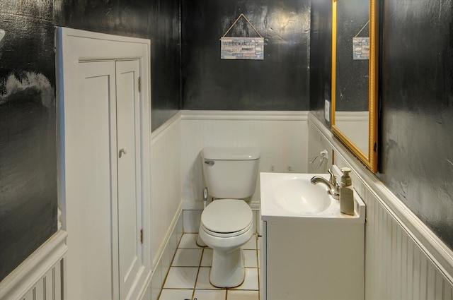 bathroom with tile patterned flooring, vanity, and toilet