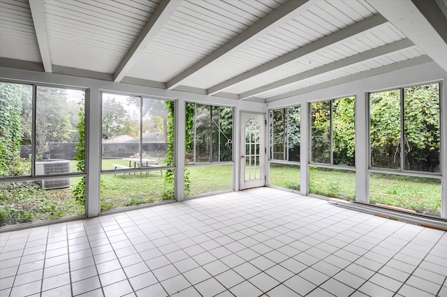 unfurnished sunroom featuring beam ceiling and a wealth of natural light