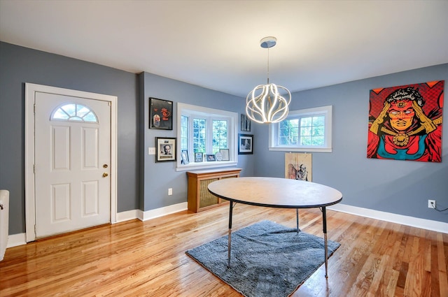 dining room with a chandelier and light hardwood / wood-style flooring