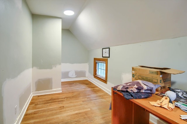 office area with light hardwood / wood-style flooring and lofted ceiling