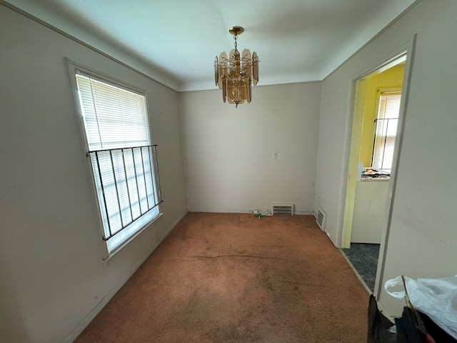 carpeted dining space featuring an inviting chandelier