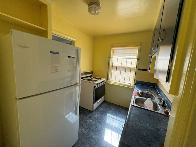 kitchen featuring decorative backsplash, white appliances, and sink