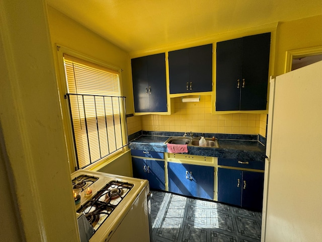 kitchen featuring tasteful backsplash, white gas range, and sink