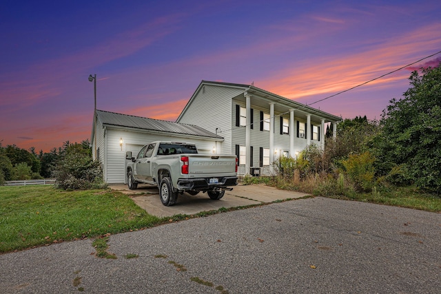 view of front of home with a yard and a garage