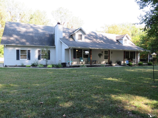 cape cod house featuring covered porch and a front yard