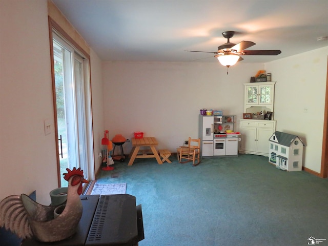 recreation room featuring carpet, ceiling fan, and a wealth of natural light