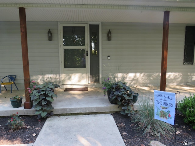 view of exterior entry with a porch