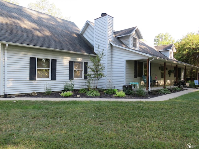 view of property exterior with a yard and a patio