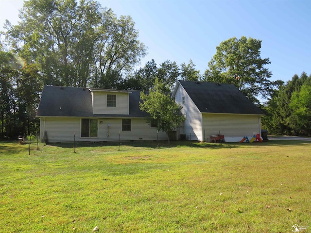 rear view of house with a yard