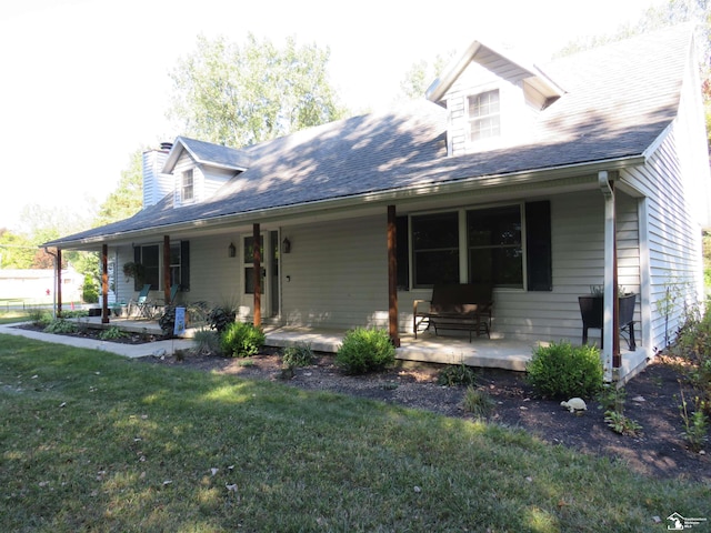 new england style home featuring a front yard and a porch