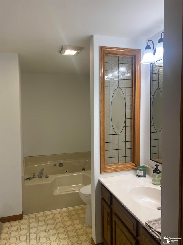 bathroom featuring a bathtub, vanity, and toilet