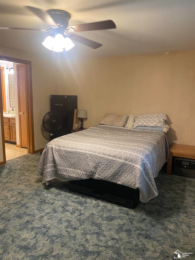 carpeted bedroom featuring ceiling fan and ensuite bathroom