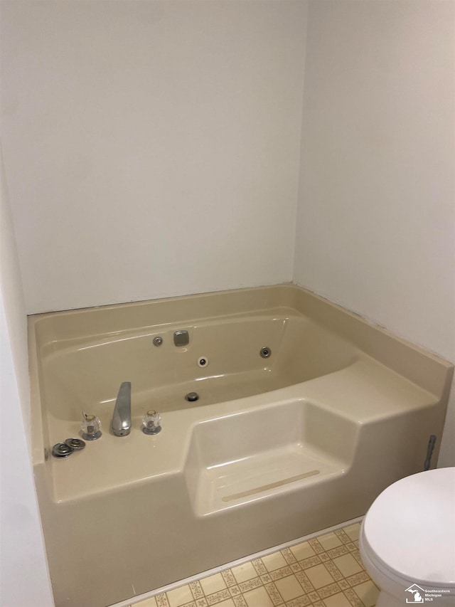 bathroom featuring a bath and toilet