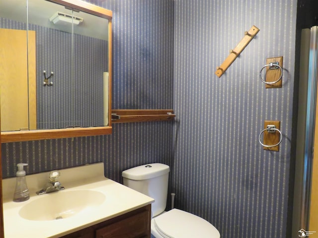 bathroom featuring vanity and toilet