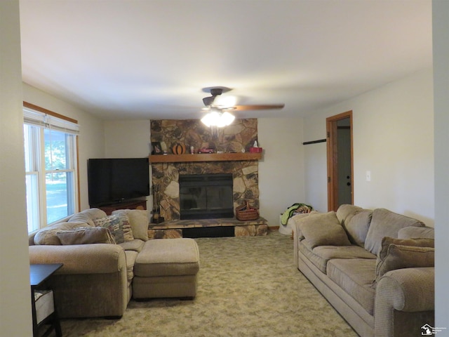 living room featuring carpet flooring, ceiling fan, and a fireplace