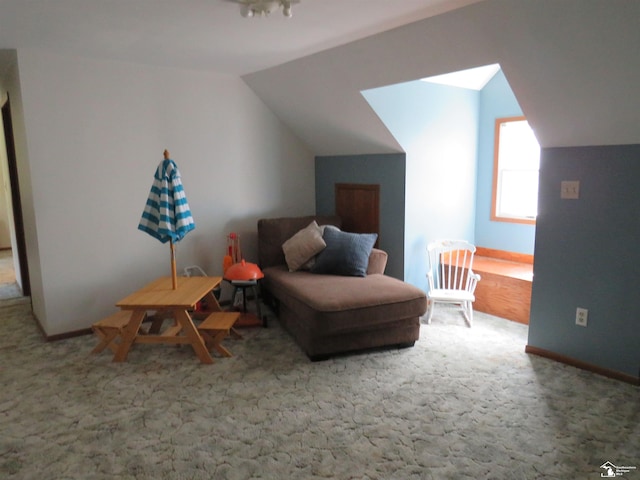 living area featuring carpet floors and lofted ceiling