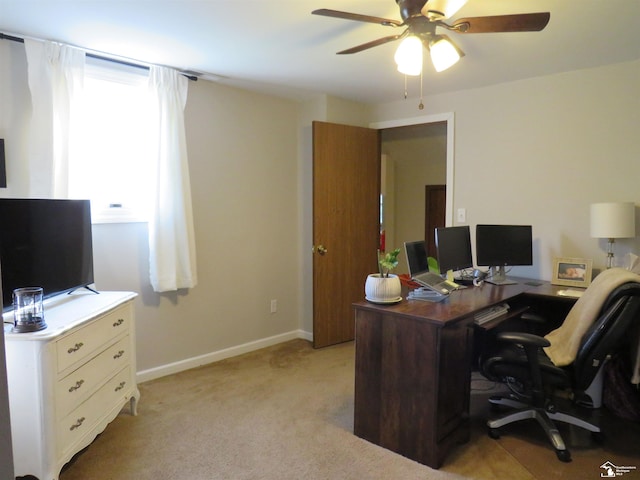 carpeted home office with ceiling fan