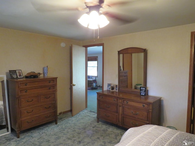 bedroom with ceiling fan and light carpet