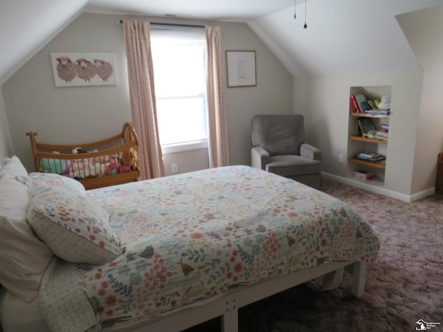 carpeted bedroom with lofted ceiling