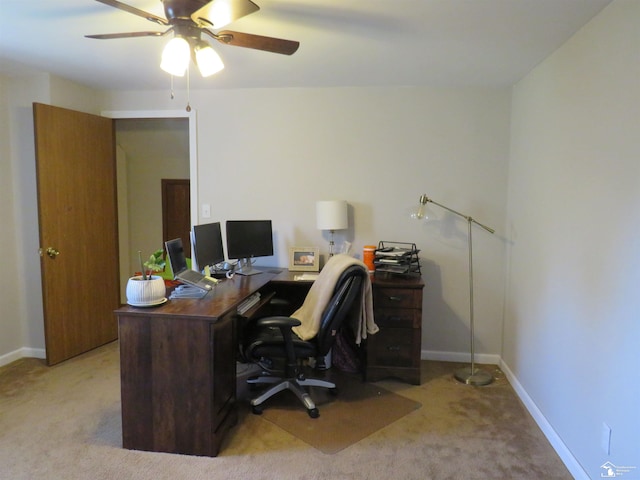 office space featuring light carpet and ceiling fan