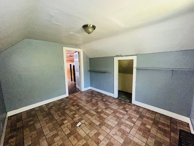 additional living space featuring lofted ceiling